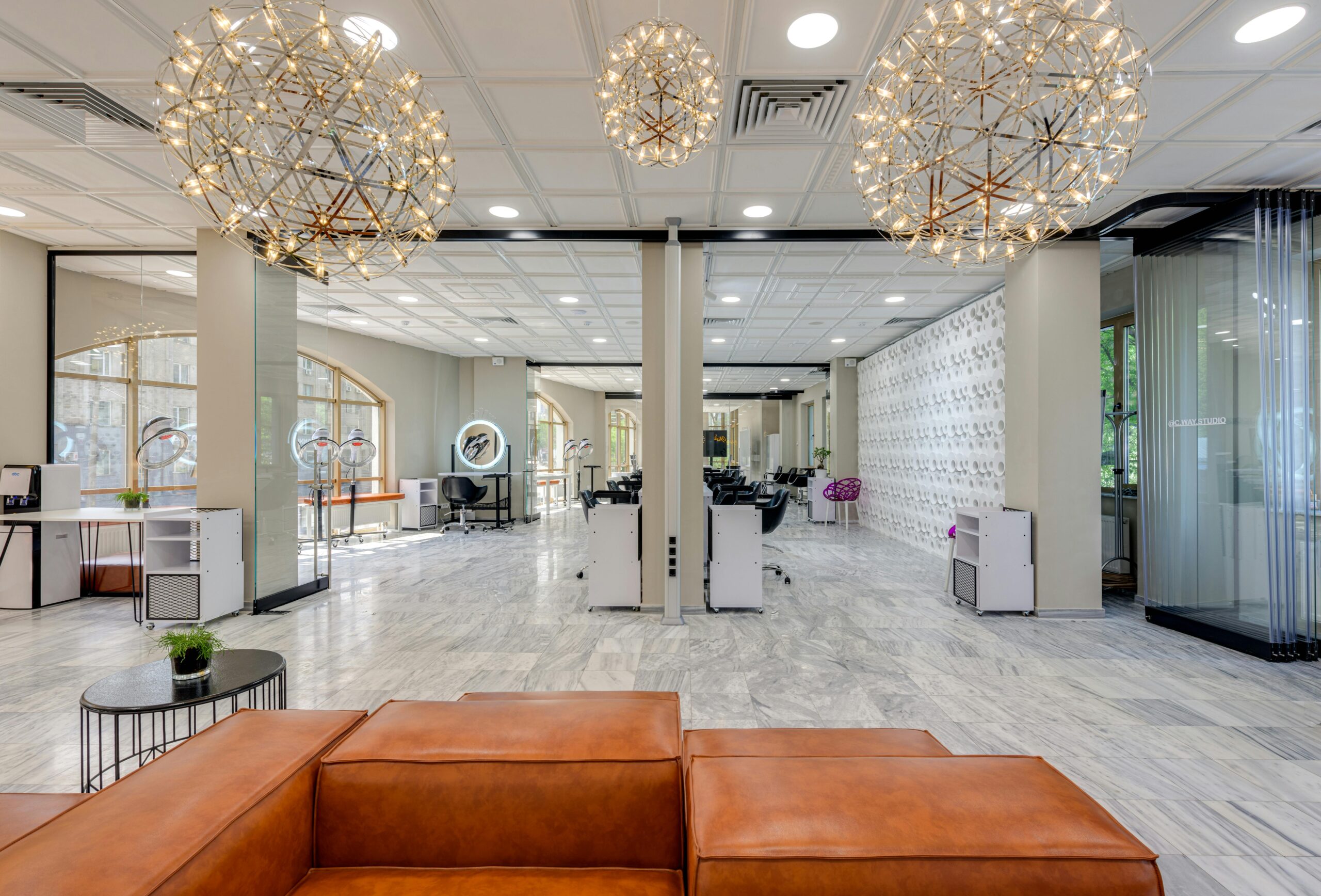 Bright and spacious beauty salon lobby with stylish decor and modern lighting features.